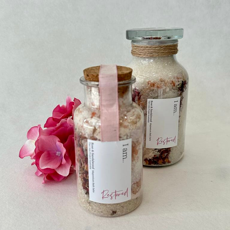 Artisan-crafted botanical bath salts infused with the delicate essence of rose and the soothing aroma of sandalwood, offering a serene and rejuvenating bathing experience.